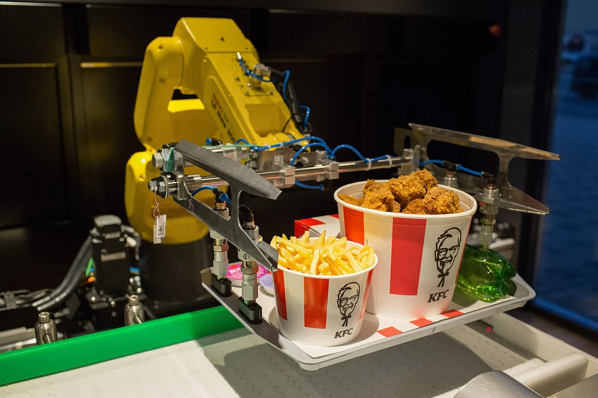 A robotic arm lifts an order from a conveyor at a contactless KFC restaurant ahead of its official opening in Moscow on June 12. Photographer: Andrey Rudakov/Bloomberg 