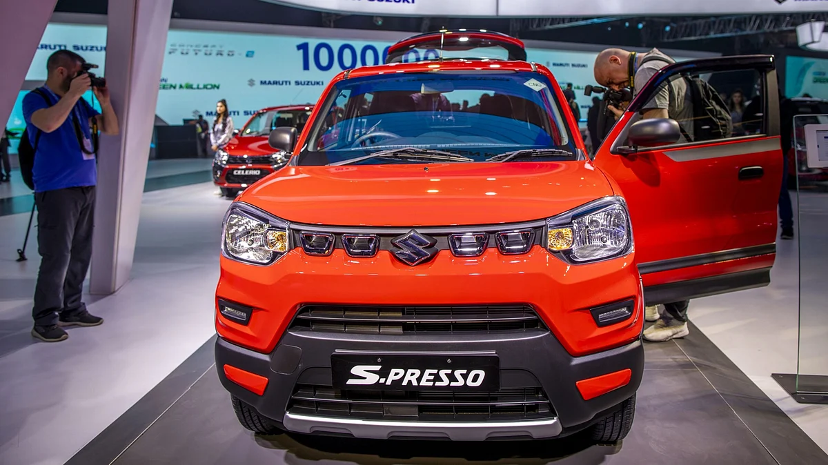 Members of the media takes photographs of a Maruti Suzuki India Ltd. S-Presso mini sports utility vehicle (SUV) on display at the Auto Expo 2020 in Noida. (Photographer: Prashanth Vishwanathan/Bloomberg)
