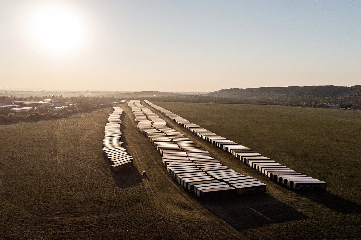Unused truck trailers sit in an airfield near Budapest, Hungary, on April 8. Photographer: Akos Stiler/Bloomberg 