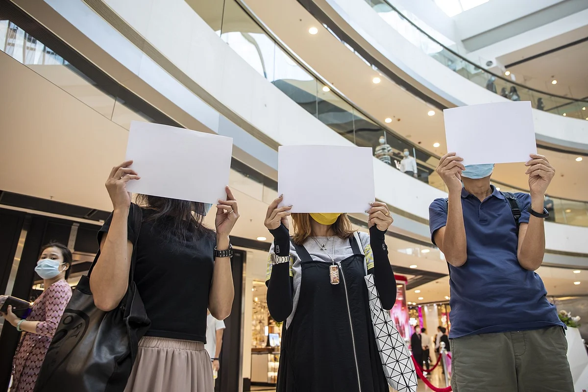 In Hong Kong, demonstrators hold blank signs at a lunchtime democracy protest in a shopping mall on July 6. The China-controlled territory’s government declared illegal a key slogan chanted by hundreds of thousands of protestors. Photographer: Paul Yeung/Bloomberg 