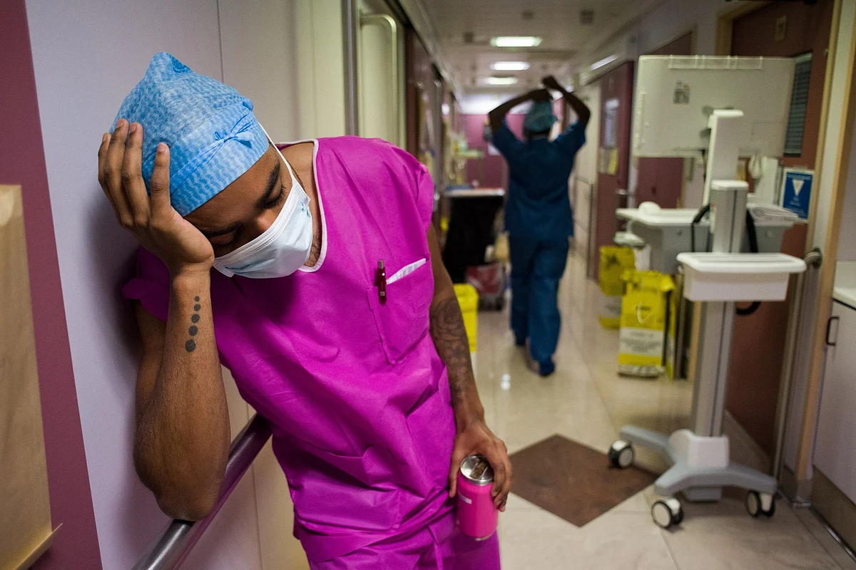 A medic briefly rests in the Ambroise Paré Clinic ICU in Paris on April 15. Photographer: Nathan Laine/Bloomberg