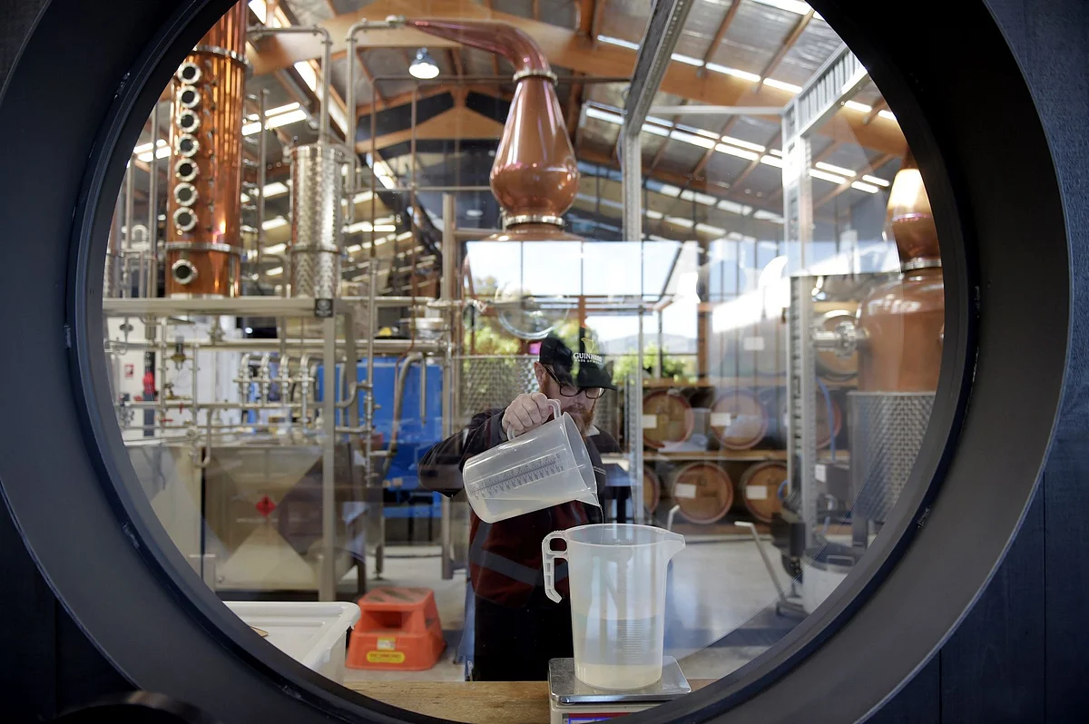 A man produces hand sanitizer at the Four Pillars Gin Distillery in Healesville, Australia, on April 1. Many industries retooled to help with shortages of protective equipment and disinfectant. Photographer: Carla Gottgens/Bloomberg 