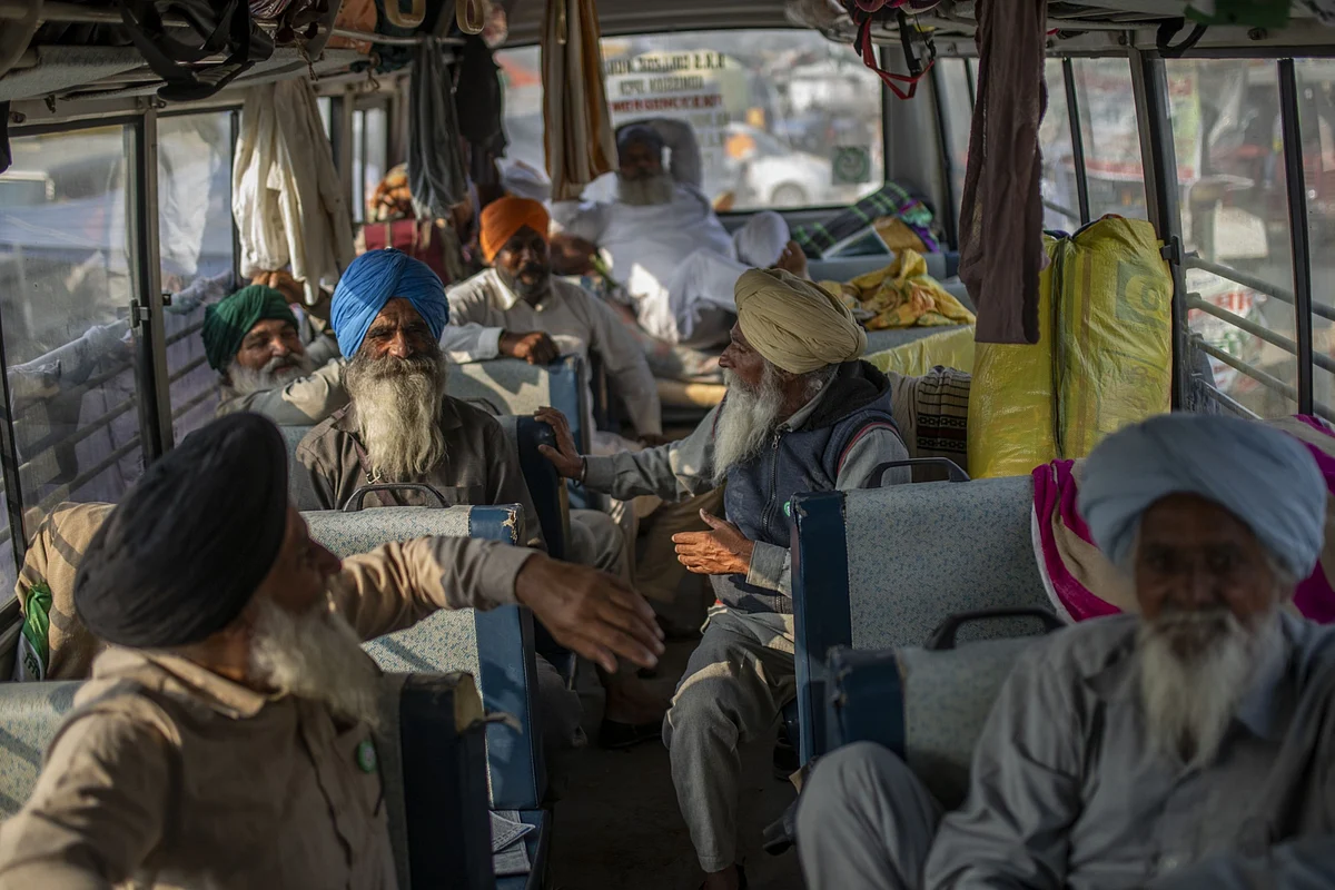 Farmers sit inside a bus at a protest site at a road block on the Delhi-Haryana border crossing in Singhu, Delhi, India. (Photographer: Prashanth Vishwanathan/Bloomberg)