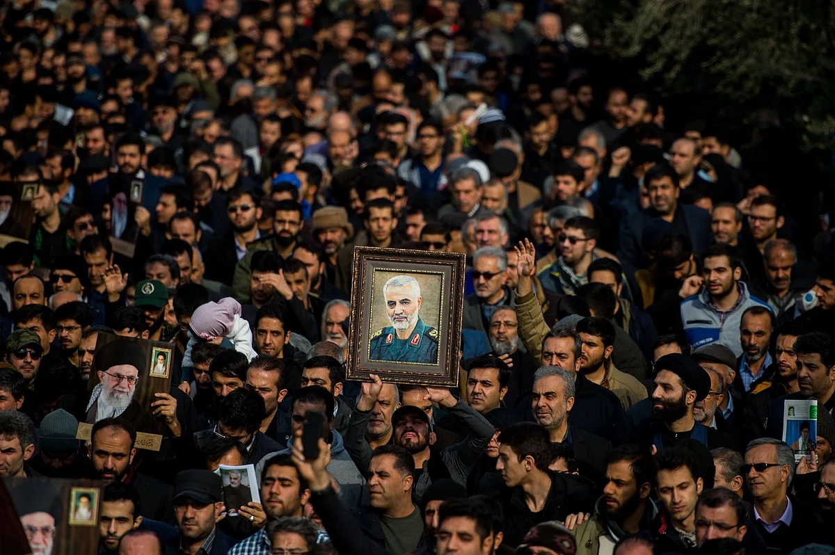 Demonstrators in Tehran on Jan. 3 hold up an image of Qassem Soleimani. The Iranian commander, who directed proxy militias across the Middle East, was ordered assassinated by U.S. President Donald Trump. Photographer: Ali Mohammadi/Bloomberg 