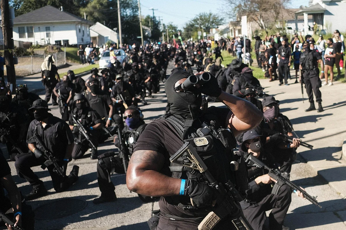 Armed anti-police violence demonstrators keep watch during a protest in Kentucky on Sept. 5. They gathered after Breonna Taylor, a Black emergency medical technician, was shot dead by White Louisville police as she slept in her home. Photographer: Matthew Hatcher/Bloomberg 