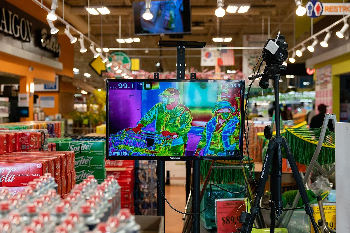 A thermal camera registers customers’ temperatures at a supermarket in Duluth, Georgia, on March 26. Photographer: Elijah Nouvelage/Bloomberg 