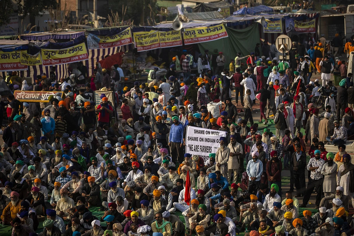 Farmers gather for a speech at a protest site at a road block on the Delhi-Haryana border crossing in Singhu, Delhi, India. (Photographer: Prashanth Vishwanathan/Bloomberg)