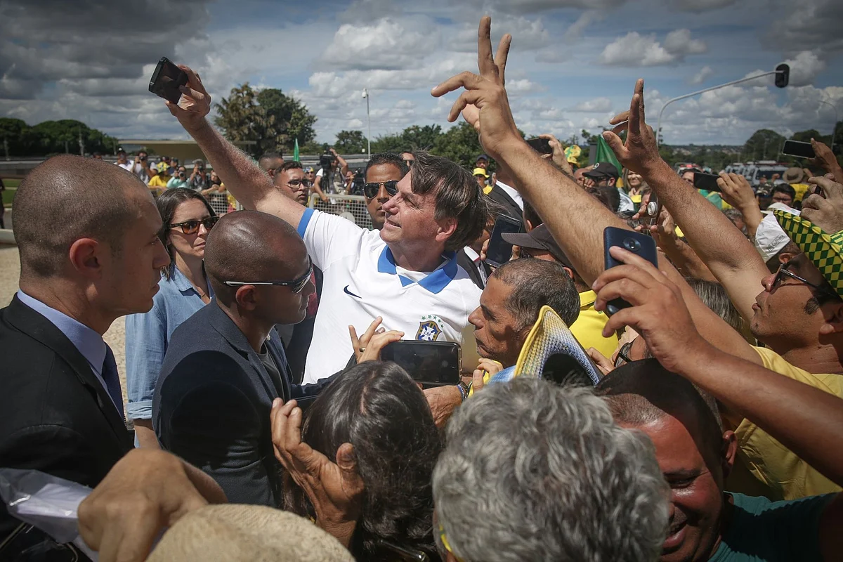 Brazil President Jair Bolsonaro, who later became infected with Covid-19, takes a selfie with supporters during a demonstration in Brasilia on March 15. Photographer: Andre Coelho/Bloomberg 