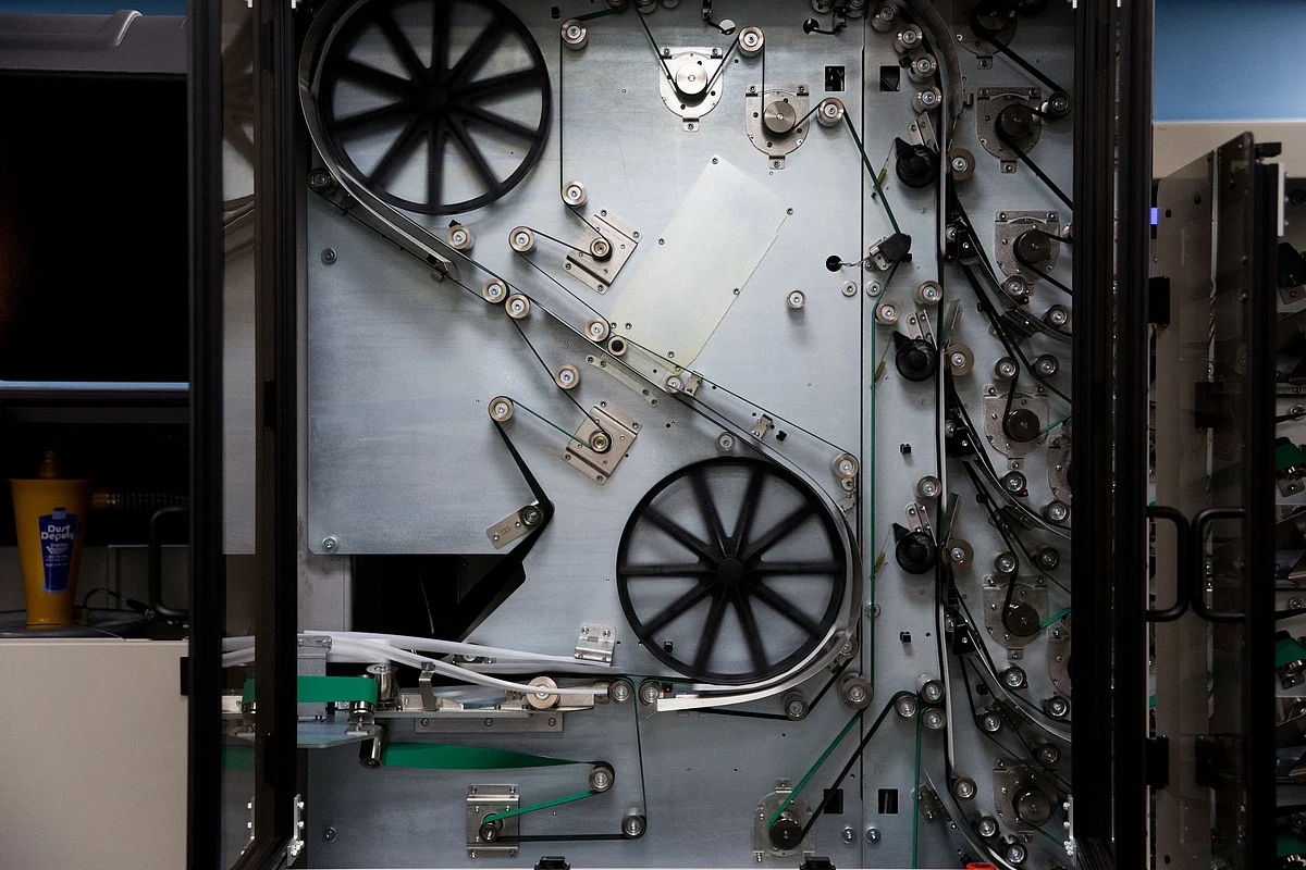 Sample voting ballots pass through a 40-foot sorter at the Board of Elections in Doylestown, Pennsylvania, on Sept. 22. U.S. counties invested millions of dollars to cope with mail-in votes during the election. Photographer: Rachel Wisniewski/Bloomberg 