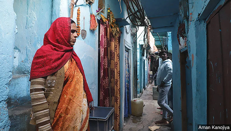 Durga Devi, who came from Bihar’s Madhubani village 20 years ago, stands outside her home in Delhi’s Okhla. She’s among several women who face hurdles at every step of the way when it comes to work, whether being the first to lose jobs during the pandemic or putting in extra hours on household chores. 