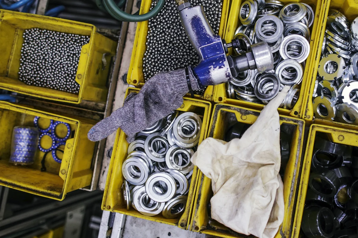 Auto parts sit in containers on the Royal Enfield production line, in Chennai. (Photographer: Dhiraj Singh/Bloomberg)