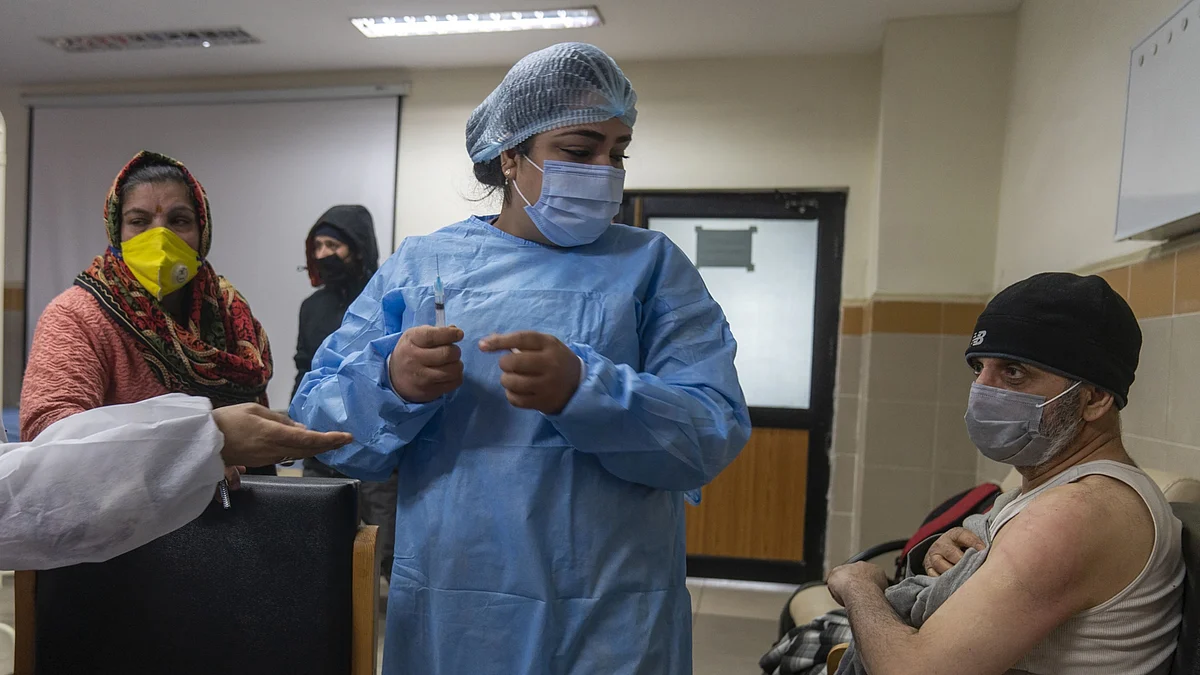 A health worker prepares a dose of Covaxin in the Covid-19 vaccination room at the Super Speciality Hospital Hospital in Srinagar, India. (Photographer: Sumit Dayal/Bloomberg)