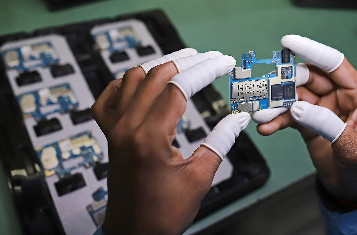 A worker inspects a circuit board for a smartphone at Dixon Technologies' factory in Noida, Uttar Pradesh, on Jan. 28, 2021. (Photographer: Anindito Mukherjee/Bloomberg)