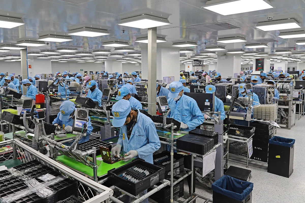 Workers assemble mobile phones at a factory in Noida, Uttar Pradesh, on Jan. 28, 2021. (Photographer: Anindito Mukherjee/Bloomberg)