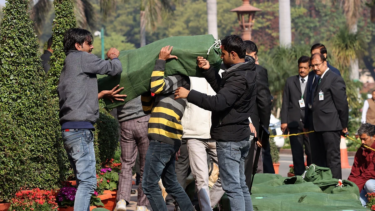 Officials carry a sack of budget papers into Parliament House in New Delhi, on Feb. 1, 2020. (Photographer: T. Narayan/Bloomberg)