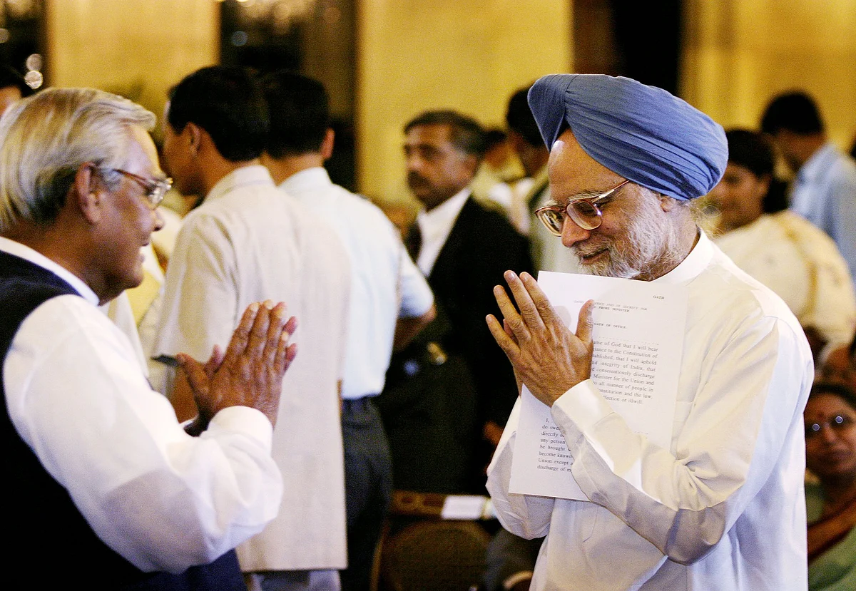 Manmohan Singh greets Atal Bihari Vajpayee, at Rashtrapati Bhavan in New Delhi, on May 22, 2004. (Photographer: Amit Bhargava/Bloomberg News)