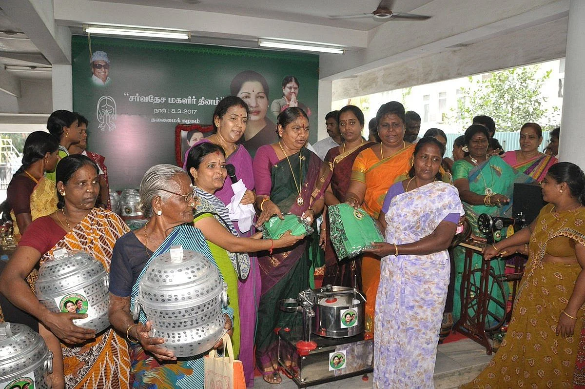 AIADMK party workers hand out cookers, grain mixers, sarees, and sewing machines. (Photograph: Twitter/@AIADMKOfficial)
