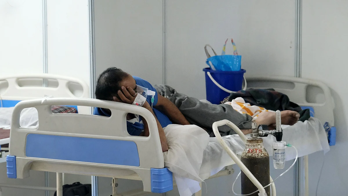 A patient receives medical oxygen in a ward at the Covid-19 Care Center set up at the Commonwealth Games Village Sports Complex in New Delhi. (Photographer: T. Narayan/Bloomberg)