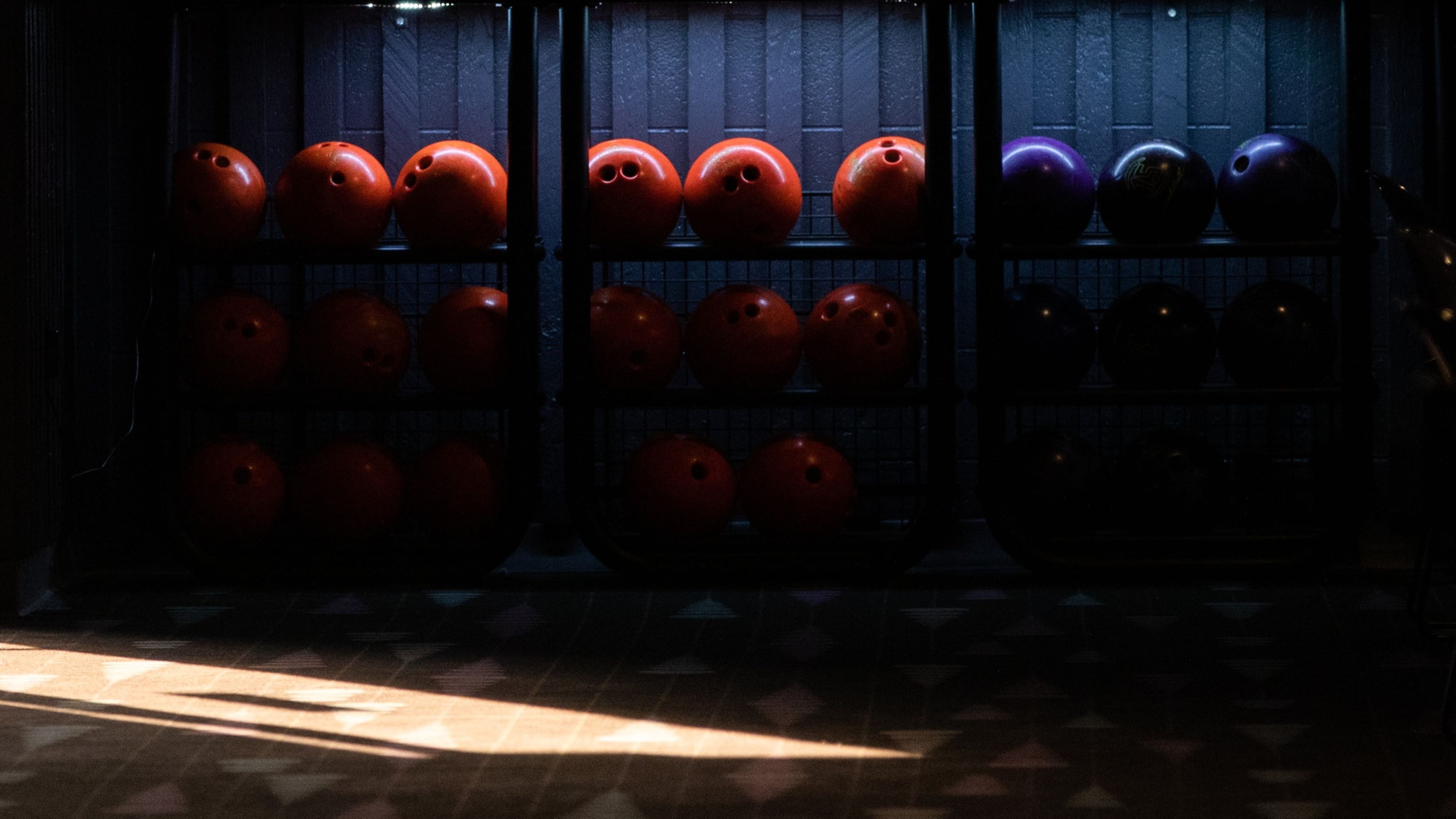 A row of coloured ten pin bowling balls at an alley. Photographer: Emily Elconin/Bloomberg