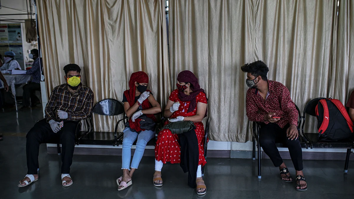 People wait in an observation area after receiving a dose of Bharat Biotech Ltd. Covaxin vaccine at a Covid-19 vaccination center at a municipal hospital in Pune. (Photographer: Dhiraj Singh/Bloomberg)