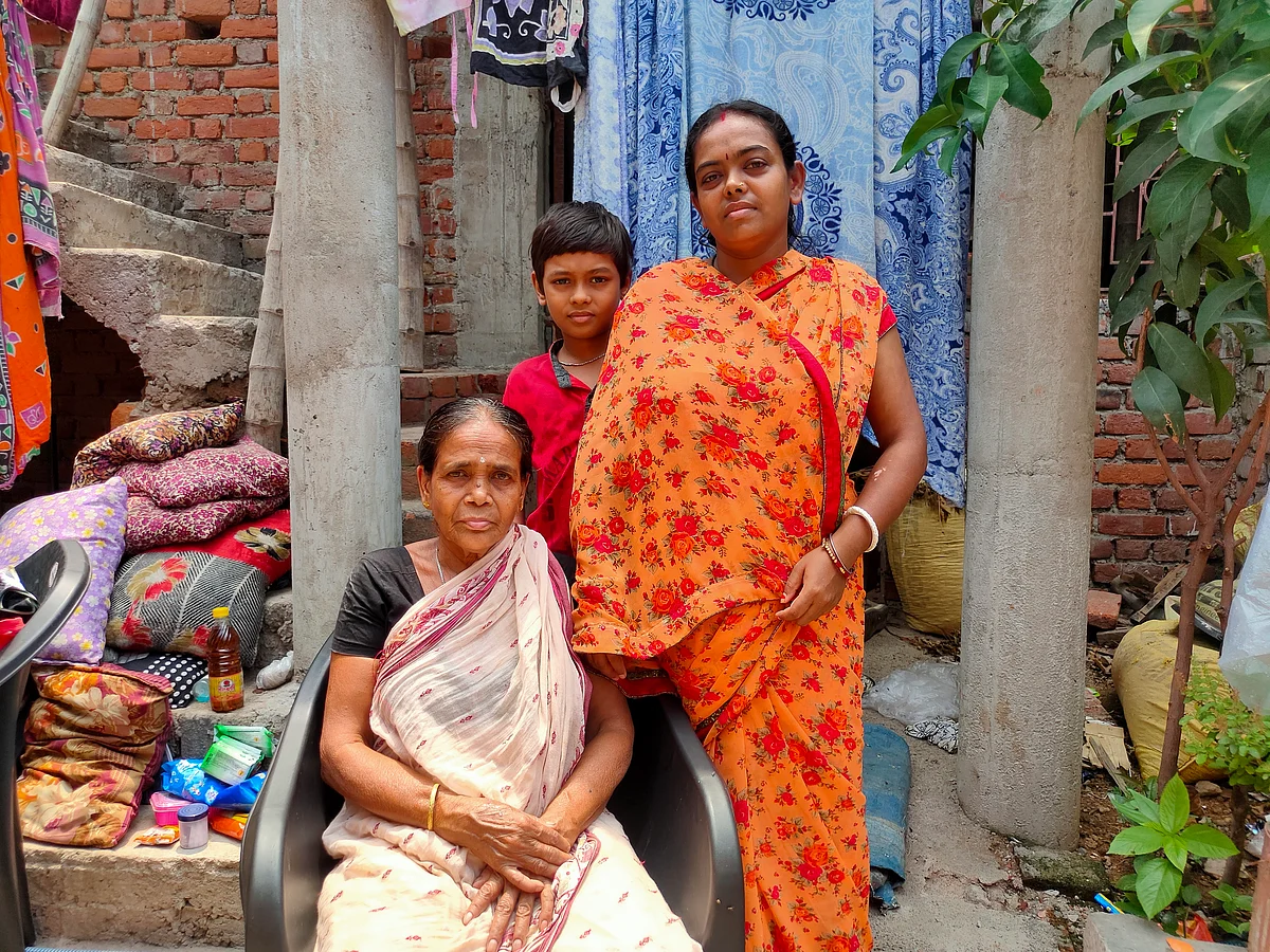Right to Left: Suman Nandy, standing next to her mother seated on the chair, and her son.