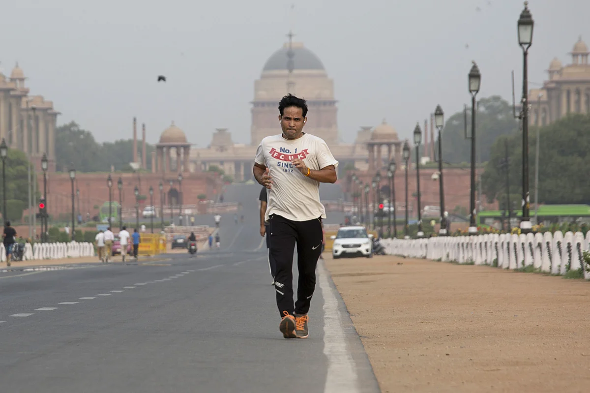 <div class="paragraphs"><p>A man jogs along Rajpath, as Rashtrapati Bhavan sits in the background in in New Delhi. (Photographer: Ruhani Kaur/Bloomberg)</p></div>