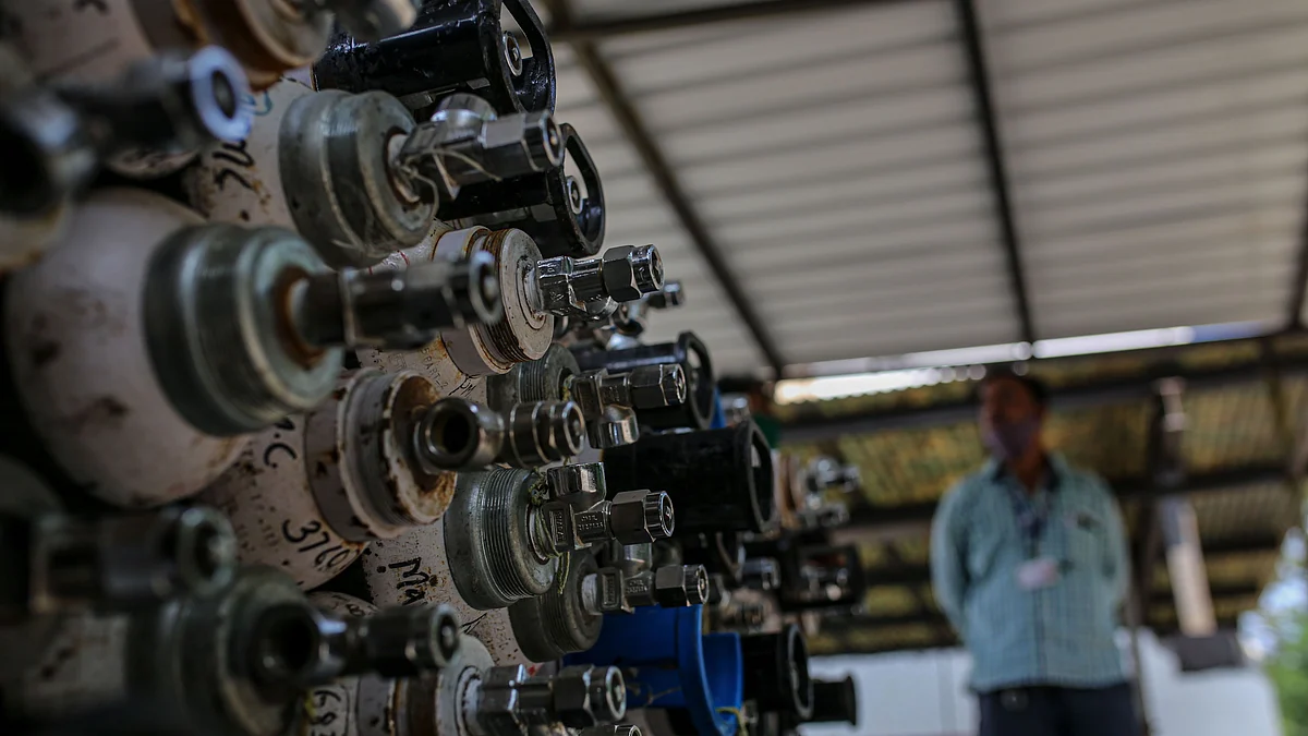 Empty oxygen cylinders are stacked in a facility at Naidu Hospital in Pune. (Photographer: Dhiraj Singh/Bloomberg)