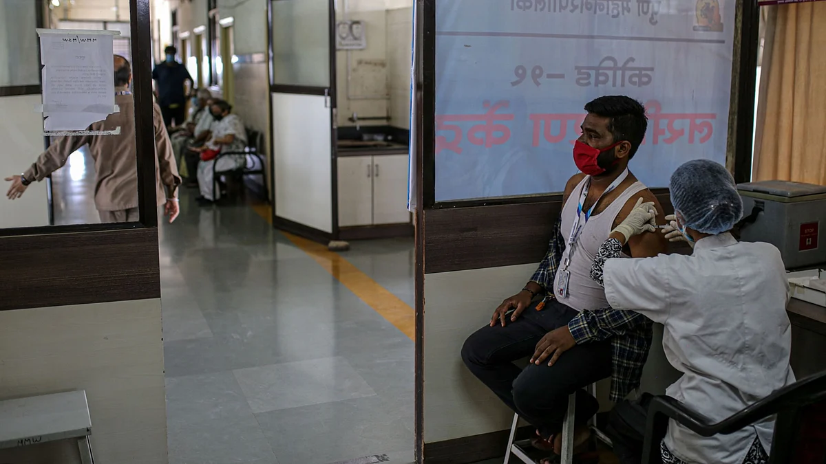 A nurse administers a dose of a Covid-19 vaccine in India. (Photographer: Dhiraj Singh/Bloomberg)