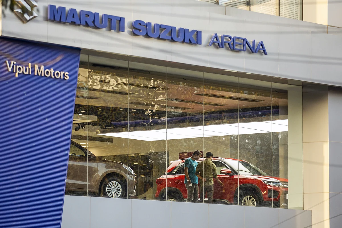 Customer look at a Maruti Suzuki India Ltd. Brezza vehicle at one of the automaker's showrooms in Noida, Uttar Pradesh, India. (Photographer: Prashanth Vishwanathan/Bloomberg)