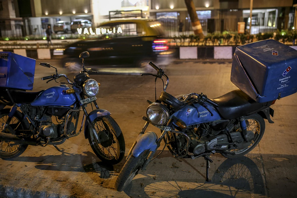 <div class="paragraphs"><p>Food delivery courier motorcycles sit parked outside a Domino's Pizza Inc. restaurant, operated by Jubilant Foodworks Ltd., at night in Mumbai, India. Photographer: Dhiraj Singh/Bloomberg</p></div>