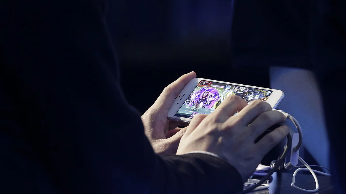<div class="paragraphs"><p>A man plays a game on a smartphone. (Photographer: Kiyoshi Ota/Bloomberg)</p></div>