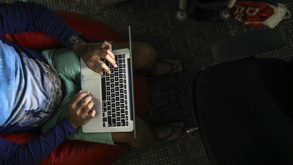 <div class="paragraphs"><p>An employee is illuminated by the screen of an Apple laptop as he works at a startup office in Mumbai. (Photographer: Dhiraj Singh/Bloomberg)</p></div>