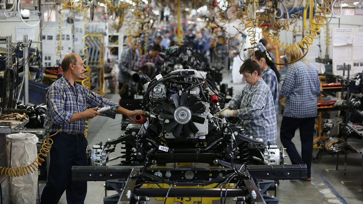 <div class="paragraphs"><p>Workers assemble engines onto a vehicle chassis on the production line. (Photographer: Andrey Rudakov/Bloomberg)</p></div>