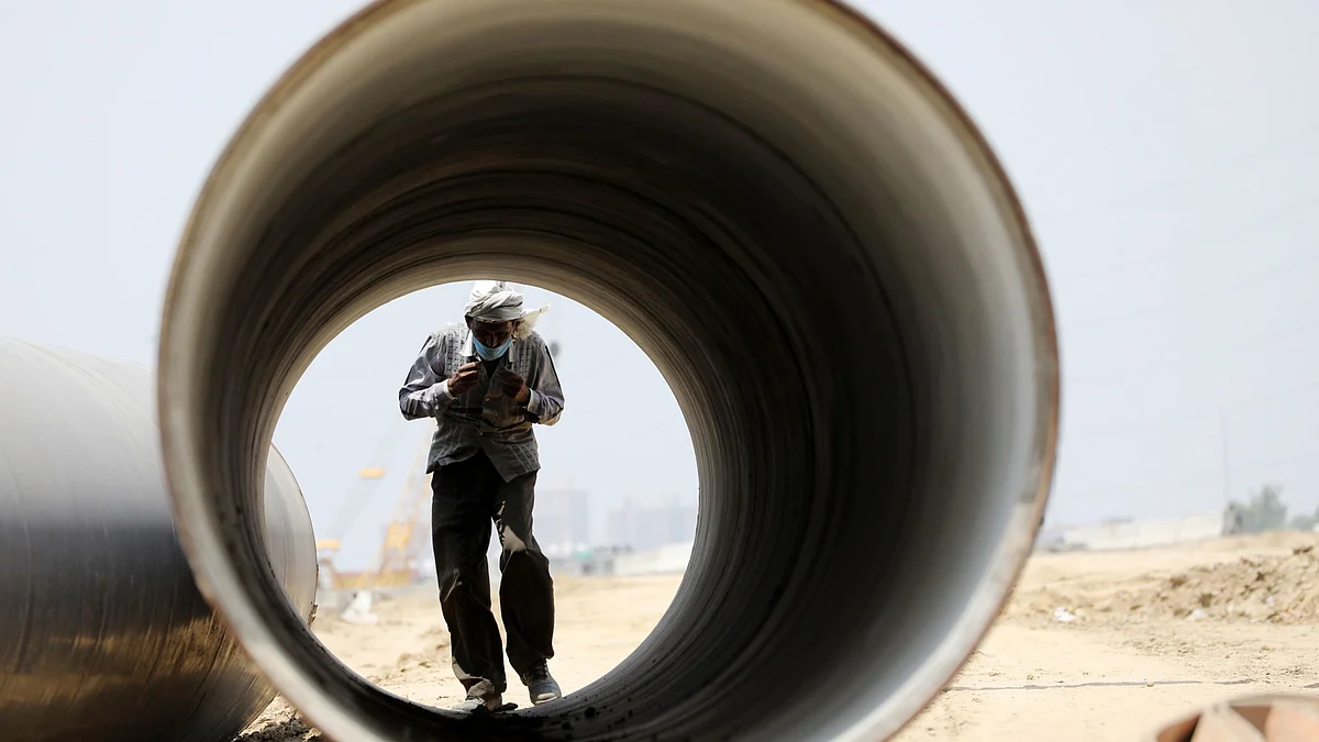 <div class="paragraphs"><p>A worker walks though a pipe at the National Highway 24 road widening and bypass project in Ghaziabad, Uttar Pradesh. (Photographer: T. Narayan/Bloomberg)</p></div>