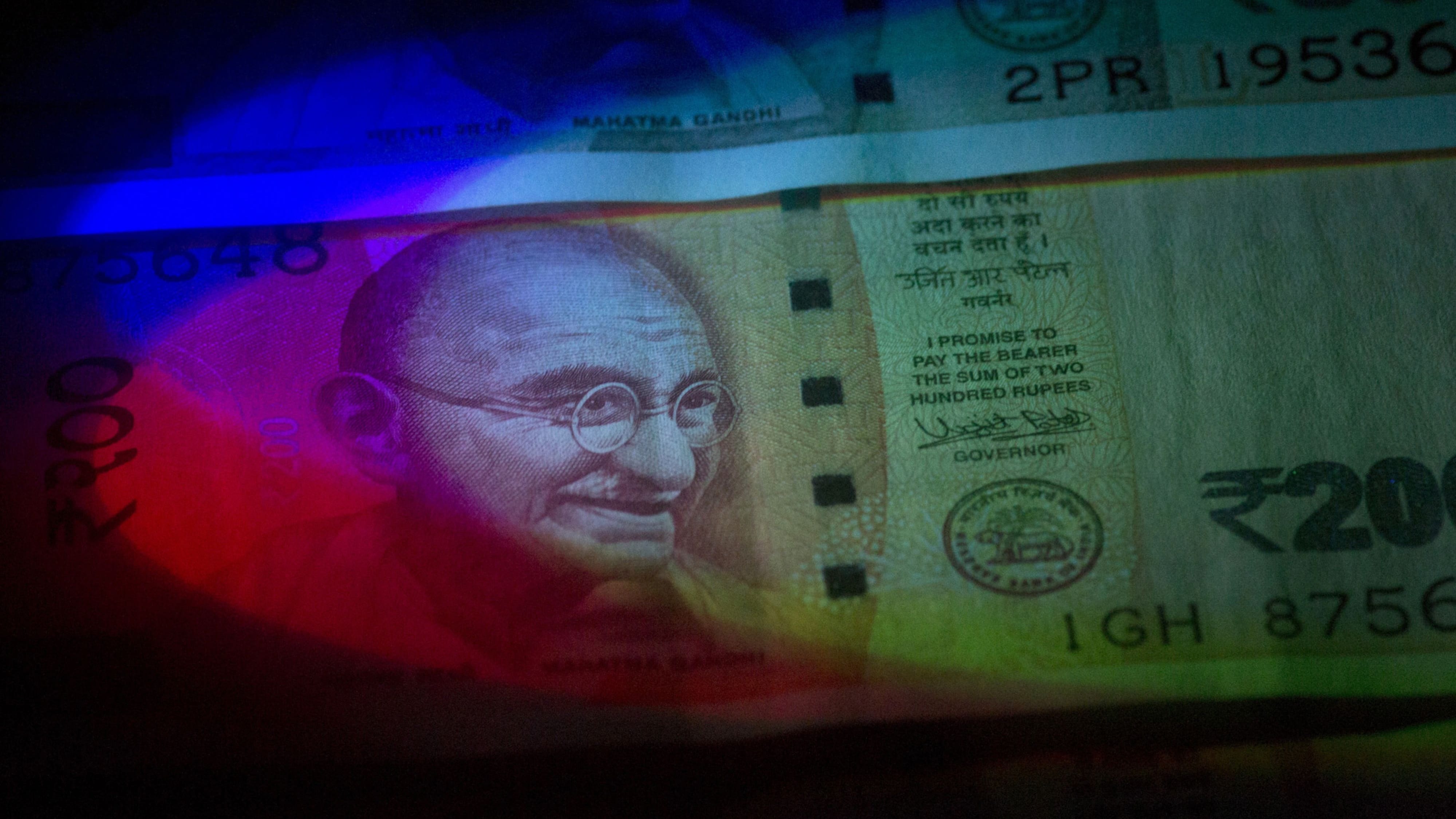 <div portrait of Mahatma Gandhi is displayed on an Indian 2,000 rupee banknote in an arranged photograph. (Photographer: Brent Lewin/Bloomberg)</p></p><p></div>