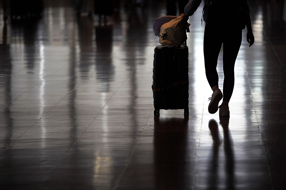 <div class="paragraphs"><p>A traveler walks in a departure hall at an Airport. (Photographer: Toru Hanai/Bloomberg)</p></div>