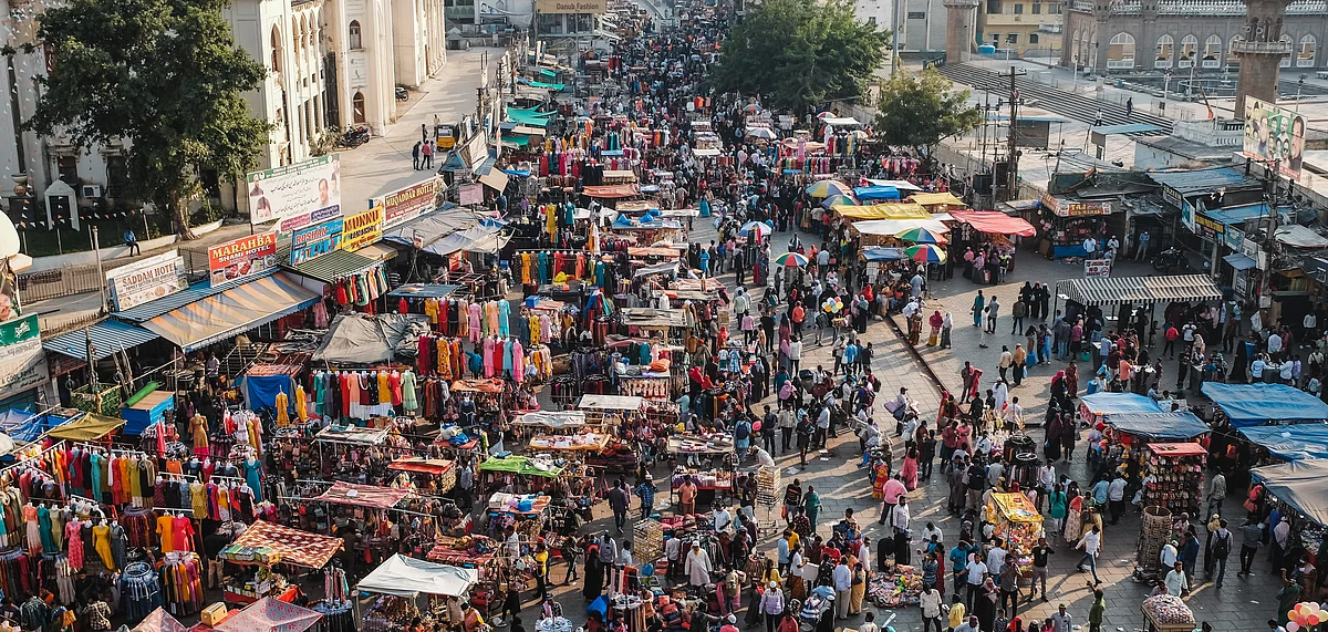 <div class="paragraphs"><p>People walk on a street in a market in India. (Photo: Tejj/Unsplash)</p></div>