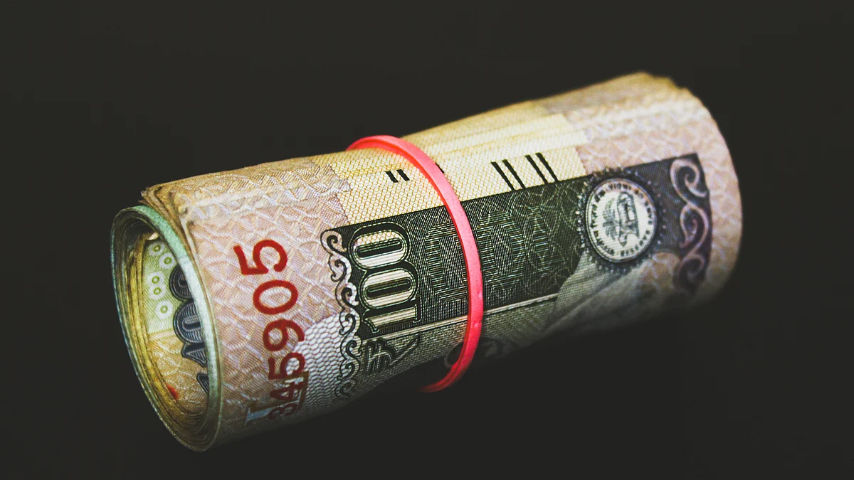 <div class="paragraphs"><p>A rolled indian rupee banknote is arranged for photograph. (Source: Unsplash)</p></div>