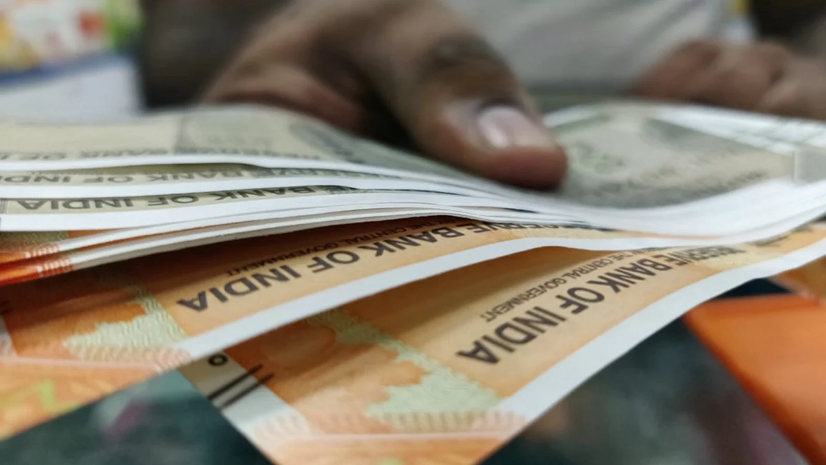 <div class="paragraphs"><p>A man holding Indian rupee banknotes. (Photo: Usha Kunji/BQ Prime)</p></div>