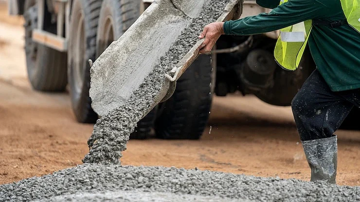 <div class="paragraphs"><p>A construction worker pouring cement mix on ground. (Source: freepik)</p></div>