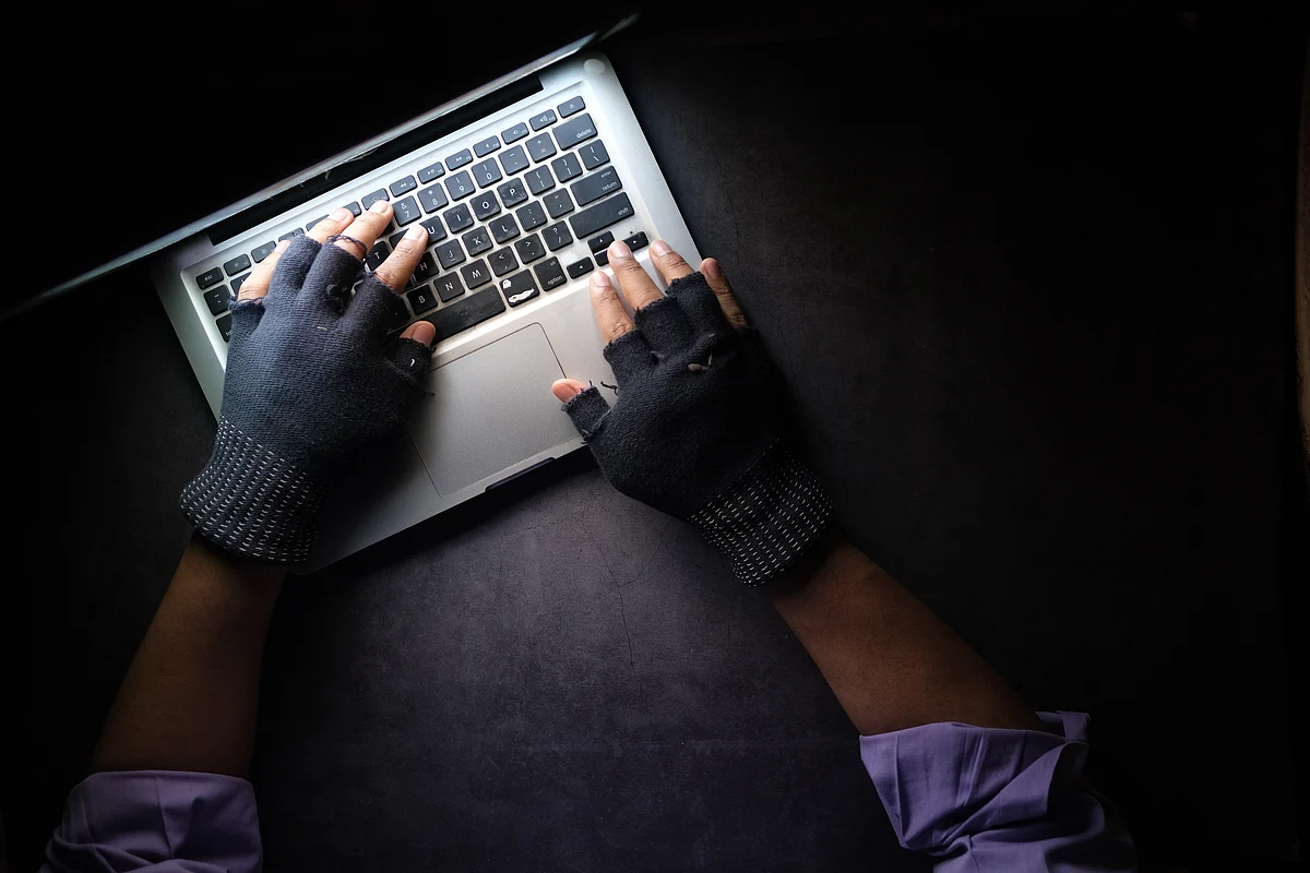 <div class="paragraphs"><p>A person in gloves using MacBook Pro. (Source: <a href="https://unsplash.com/@towfiqu999999?utm_source=unsplash&utm_medium=referral&utm_content=creditCopyText">Towfiqu barbhuiya</a>/<a href="https://unsplash.com/s/photos/cyber-attacks?utm_source=unsplash&utm_medium=referral&utm_content=creditCopyText">Unsplash</a>)</p></div>