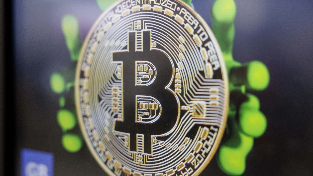 A Bitcoin logo on the screen of a cryptocurrency automated teller machine (ATM).