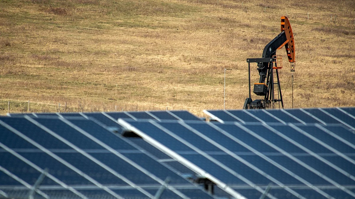 An oil pumpjack behind a bank of solar panels near Longview, Alberta, Canada, on Tuesday, April 26, 2022. Prime Minister Justin Trudeau’s government wants a 42% reduction in emissions from the oil and gas sector as part of Canada’s plan to meet its 2030 emissions-reduction goal.