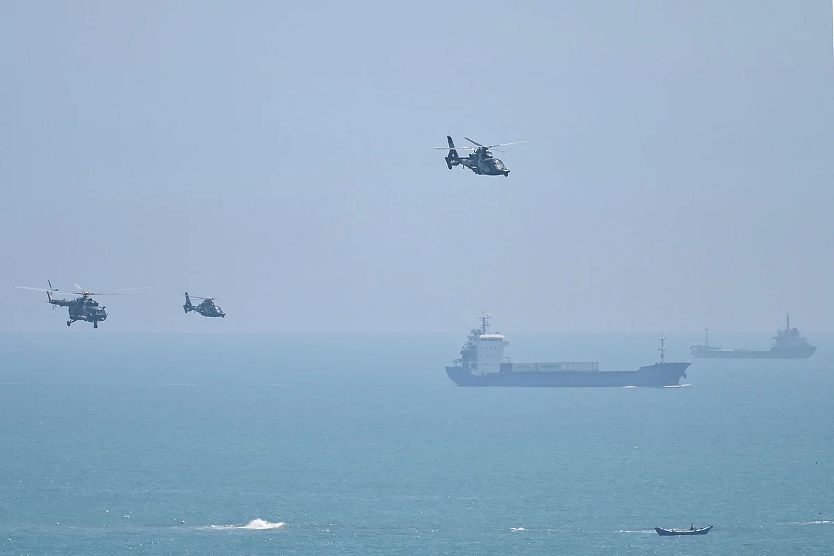<div class="paragraphs"><p>Chinese military helicopters fly past Pingtan island, one of mainland China's closest points to Taiwan. (Photographer: Hector Retamal/AFP/Getty Images)</p></div>