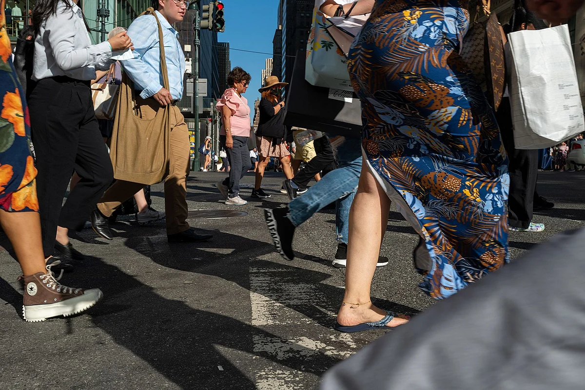People walk through midtown Manhattan on Aug. 3, 2022.