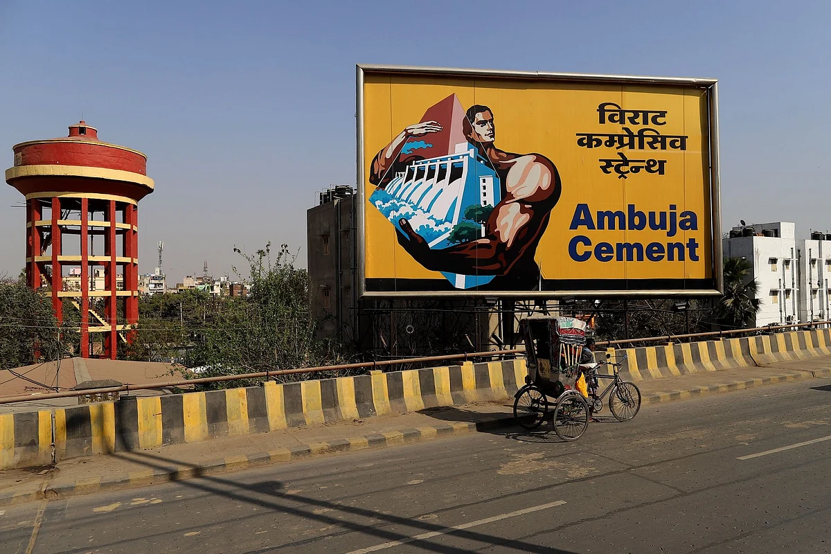 <div class="paragraphs"><p>A rickshaw-puller travels past an Abuja Cements Ltd. billboard on a highway in Patna, Bihar, India, on Thursday, Feb. 25, 2021. </p></div>