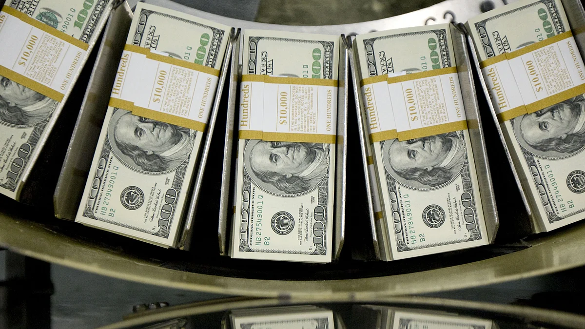 <div class="paragraphs"><p>Stacks of one hundred dollar bills pass through a circulator machine at the Bureau of Engraving and Printing in Washington, D.C.</p></div>