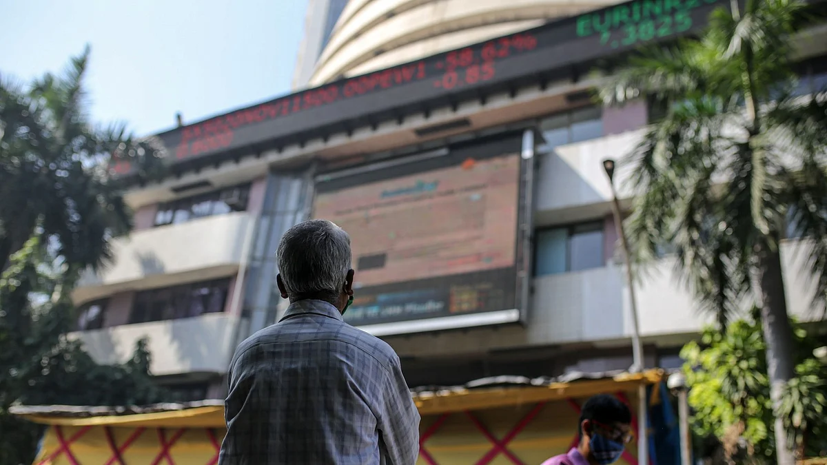 <div class="paragraphs"><p>A person looks up at a screen and an electronic ticker board outside the Bombay Stock Exchange in Mumbai. (Photo: Bloomberg)</p></div>