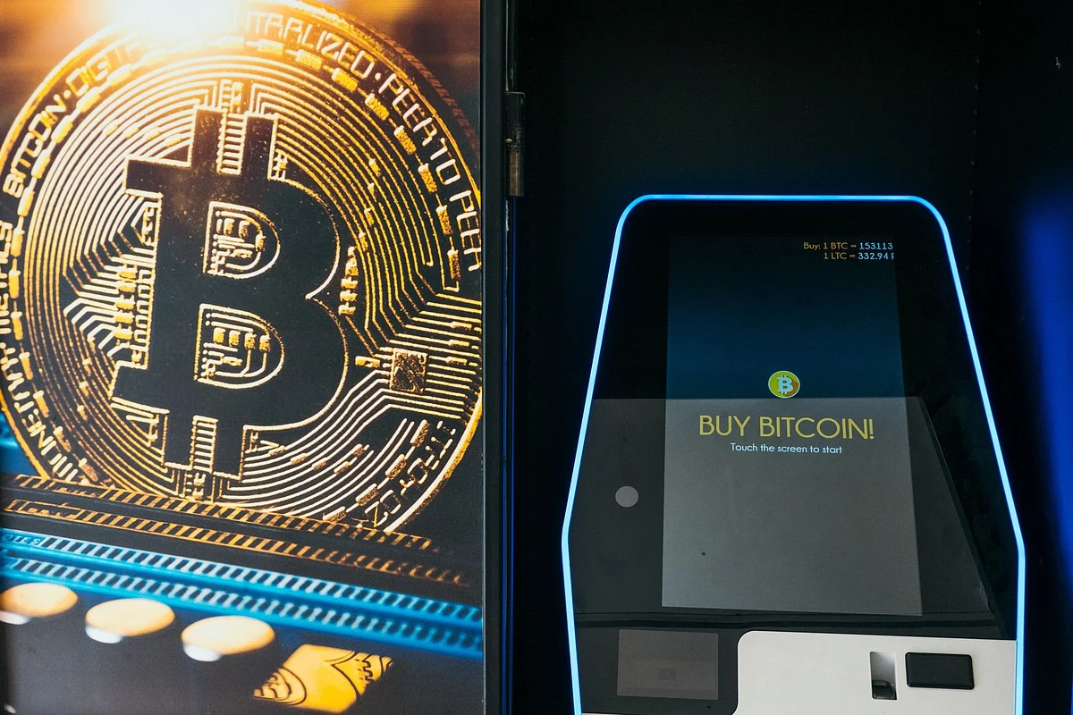 <div class="paragraphs"><p>The Bitcoin logo next to a cryptocurrency ATM in Bucharest, Romania. (Photo: Andrei Pungovschi/Bloomberg)</p></div>
