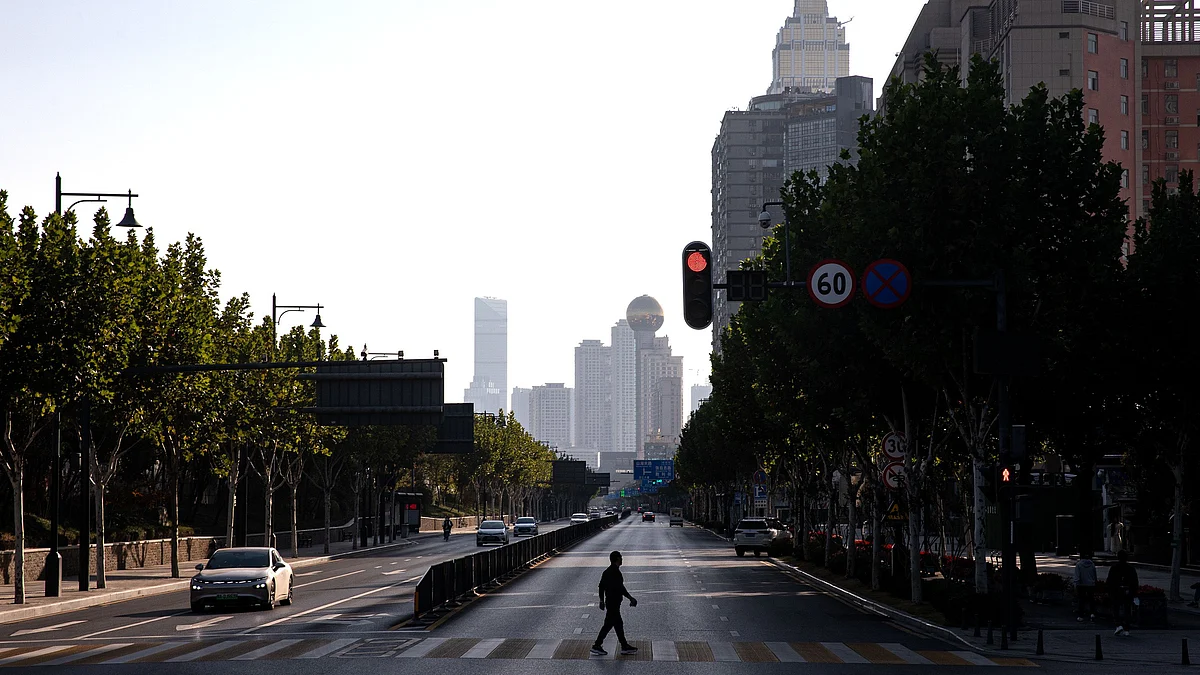 <div class="paragraphs"><p> A resident crosses a nearly deserted street at the zebra crossing in China. (Photo by Getty Images)</p></div>